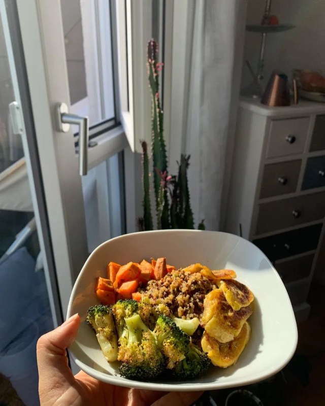 Plate of food which includes rice, broccoli, sweet plantains, and sweet potatoes. Showing a healthy meal.