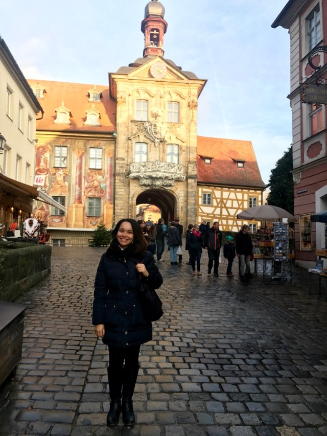 Woman standing near the famous bridge in Bamberg, Germany.