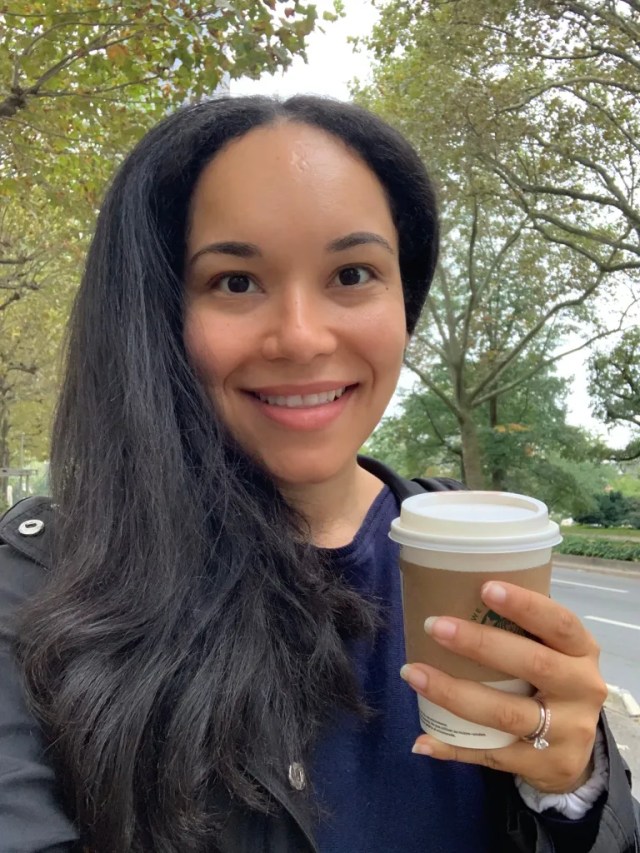 A woman in her early 30s taking a selfie while enjoying a solo walk and coffee. The photos shows a happy mom having some alone time.